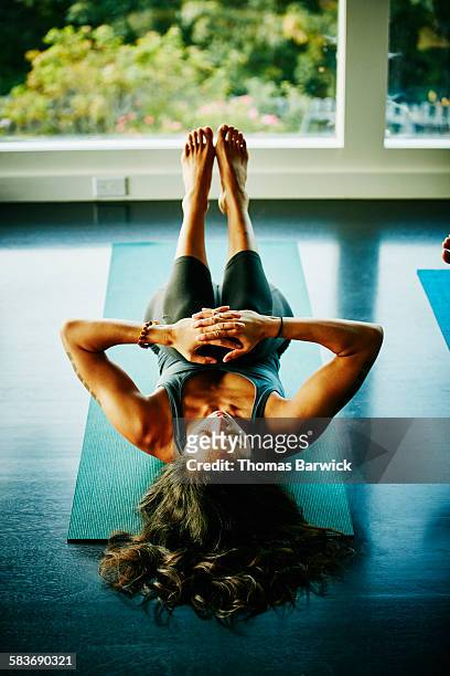 Woman resting in knee pose after yoga class