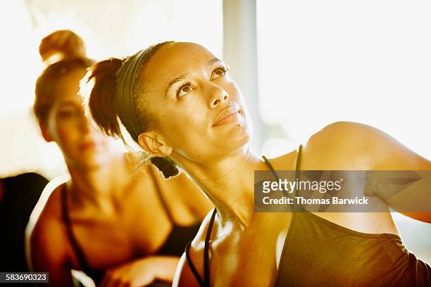 Smiling woman stretching after yoga class