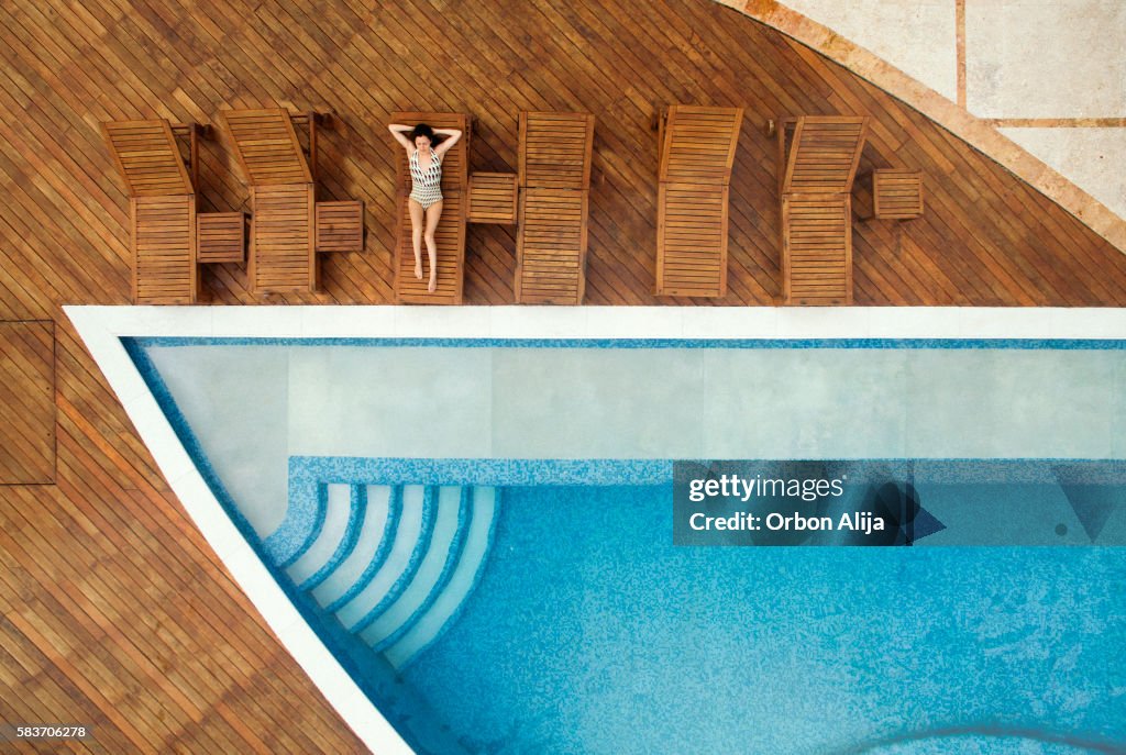 Woman relaxing at swimming pool