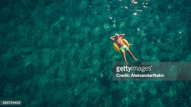 relaxing in the sea - carefree stock pictures, royalty-free photos & images