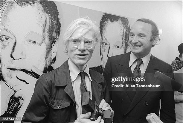 At the German consulate, American Pop Andy Warhol poses with his painting of former German Chancellor Willy Brandt, New York, New York, June 25, 1976.