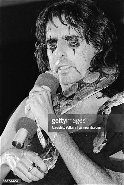 Musician Alice Cooper sings with a Python around his neck at the Nassau Coliseum, Long Island, New York, July 21, 1977.