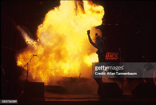 During a performance by the group the Plasmatics, musician Wendy O Williams raises her arms as a Ford Mustang is detonated onstage the Calderone...