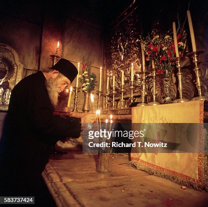 Lighting Candles in Christ's Tomb