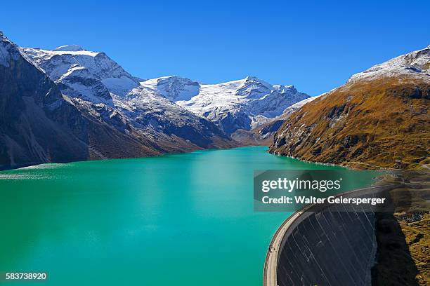 high mountains water-reservoir, austria - dam stock-fotos und bilder