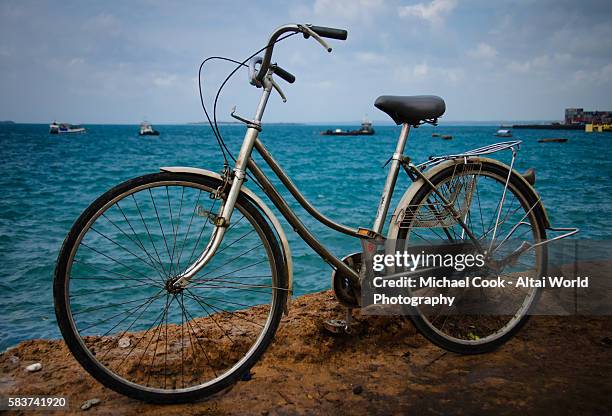 bicycle near the water's edge - stone town zanzibar town stock pictures, royalty-free photos & images