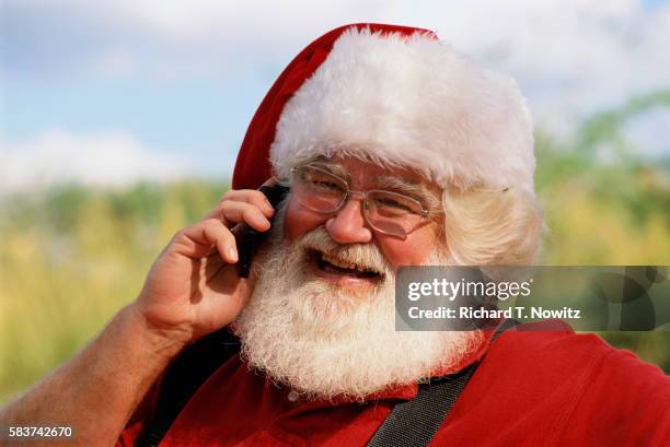 santa claus talking on a cell phone - tampa christmas stock pictures, royalty-free photos & images