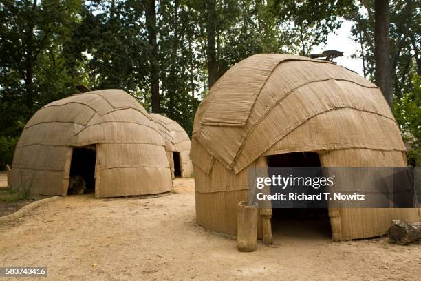 huts in replica of powhatan indian settlement - wigwam stock pictures, royalty-free photos & images