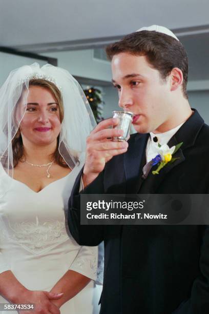groom drinking wine during ceremony - jewish wedding ceremony stock pictures, royalty-free photos & images