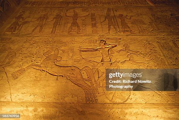 Wall relief of Ramses II charging enemies in a chariot. Abu Simbel, Egypt.