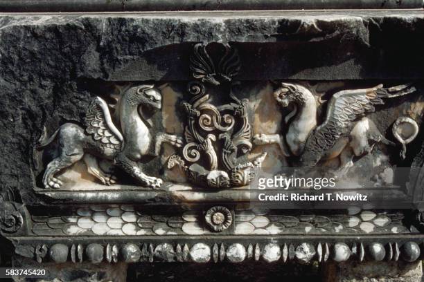 sculpted griffins at the temple of apollo - griffioen stockfoto's en -beelden