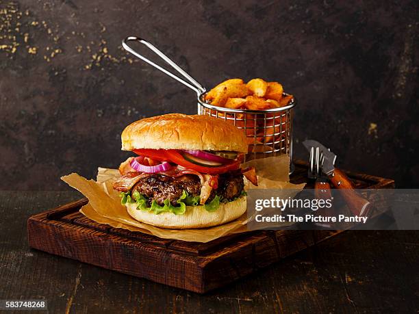burger with meat and potato wedges on dark background - potato wedges stock pictures, royalty-free photos & images