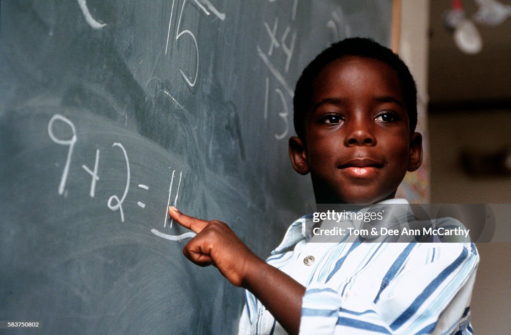 Student Solving A Math Problem At The Chalkboard High-Res Stock Photo ...