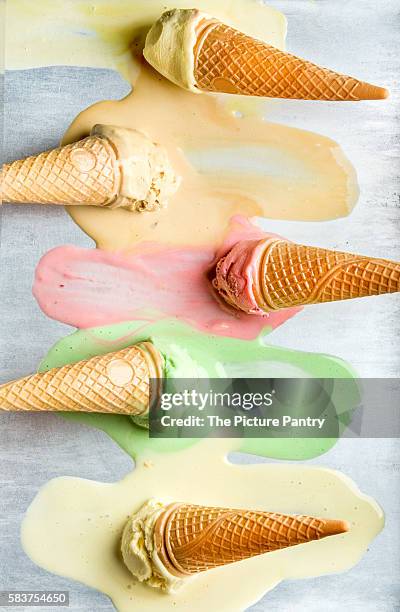 colorful ice cream cones of different flavors. melting scoops. top view - ice cream cone stock-fotos und bilder