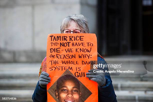 An unidentified woman protests the death of 12-year old Tamir Rice in Cleveland, Ohio, on November 26. Rice was shot by a Cleveland Police Officer...