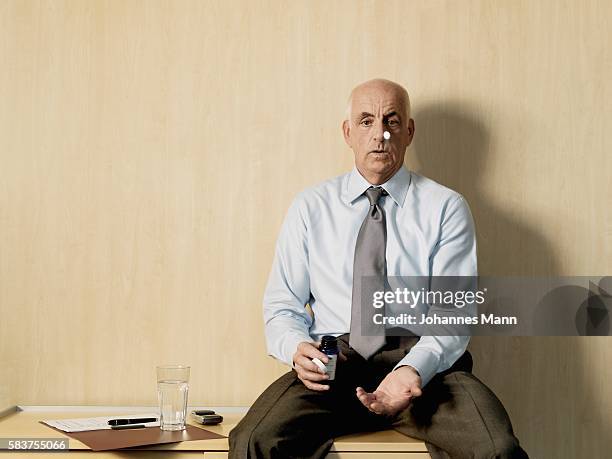 businessman tossing pill in air - lifestyle mann portrait stock pictures, royalty-free photos & images