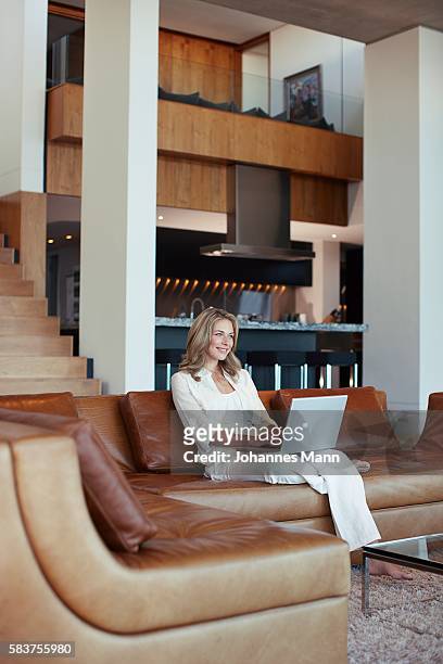 woman using laptop computer - luxury mansion interior stock pictures, royalty-free photos & images