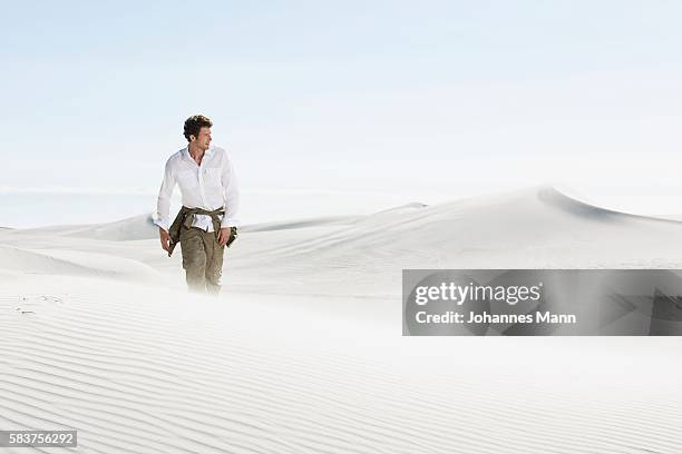 man walking through desert - approaching bildbanksfoton och bilder