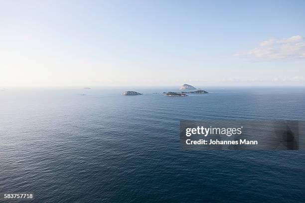 seascape with islands emerging from water - brazil ocean stock-fotos und bilder