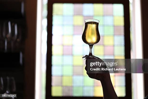 Mott holds up a glass of cider on tap. Her Father's Cider Bar + Kitchen, with owner Joshua Mott has been open for 5 weeks on Harbord near Spadina....