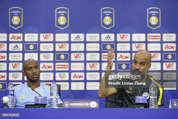 Manchester City's manager Pep Guardiola with team player Fabian Delph attends a press conference for 2016 International Champions Cup match between...