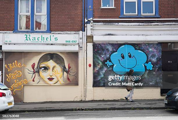 Woman passes artwork produced as part of the 2016 Upfest on July 27, 2016 in Bristol, England. The annual event, which this year helped celebrate 45...