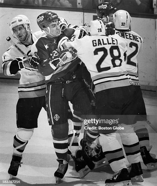 Washington Capitals player Geoff Courtnall, center, battles Boston Bruins player Bob Carpenter, left,, Garry Galley, middle, and Don Sweeney in front...