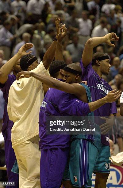 Guard Baron Davis of the Charlotte Hornets is greeted by jubilant teammates in the second half action of game five of the Eastern Conference...