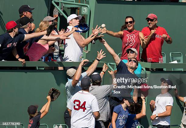 Fans catch a home run hit by Xander Bogaerts of the Boston Red Sox pitches against the Detroit Tigers in the seventh inning on July 27, 2016 at...