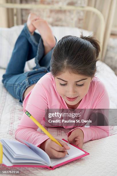Girl Writing A Routine Girl Writing In Diary High-Res Stock Photo - Getty Images