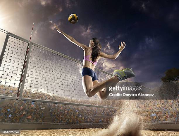 volleyball: female player in action - beach volley imagens e fotografias de stock