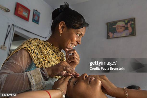 Bhavna Headod is a home based worker who has a beauty parlor. Bhavna works on a customers eyebrows at the salon.She took a micro loan for the parlor...