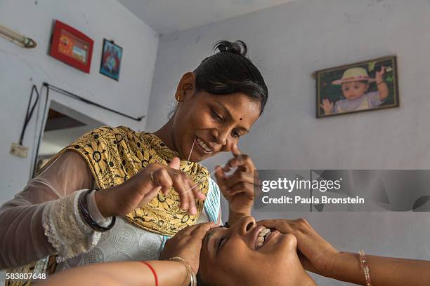 Bhavna Headod is a home based worker who has a beauty parlor. Bhavna works on a customers eyebrows at the salon.She took a micro loan for the parlor...