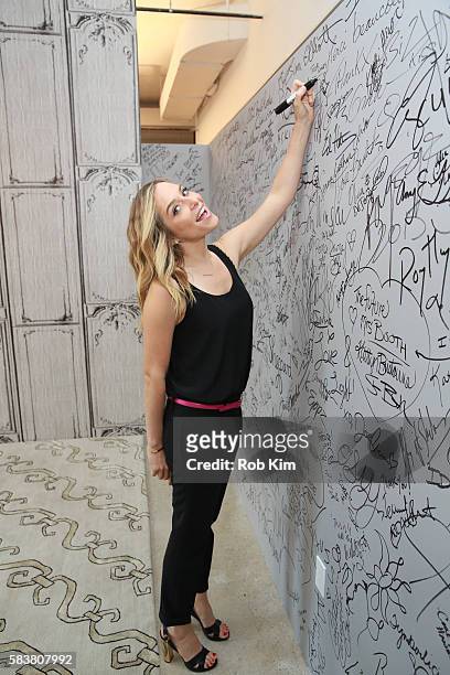 Jenny Mollen signs the wall at AOL Build at AOL HQ on July 27, 2016 in New York City.