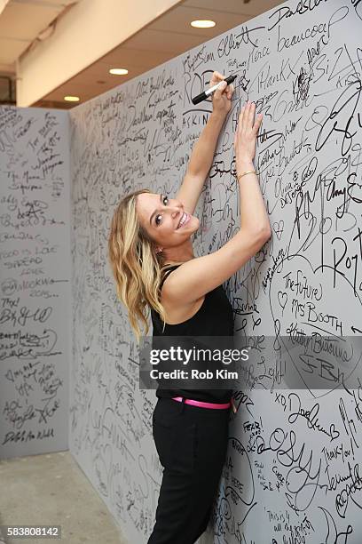 Jenny Mollen signs the wall at AOL Build at AOL HQ on July 27, 2016 in New York City.