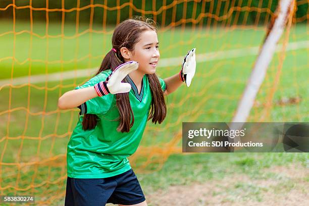 cute soccer goalie defends goal - girl goalie stock pictures, royalty-free photos & images