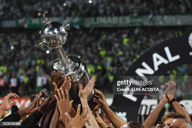 Colombia's Atletico Nacional players celebrate with the trophy after winning the 2016 Copa Libertadores at Atanasio Girardot stadium, in Medellin,...