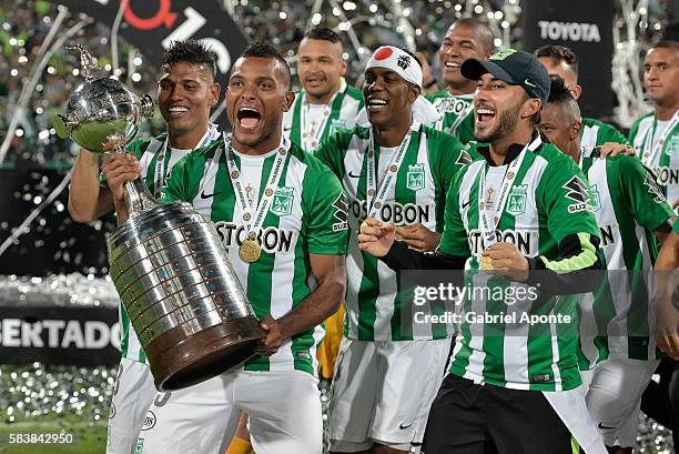 Players of Atletico Nacional celebrate with the trophy after a second leg final match between Atletico Nacional and Independiente del Valle as part...