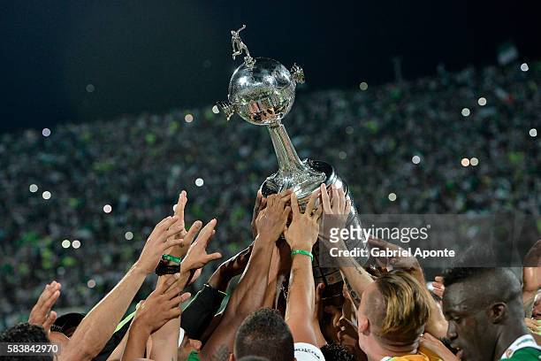 Players of Atletico Nacional lift the trophy after a second leg final match between Atletico Nacional and Independiente del Valle as part of Copa...