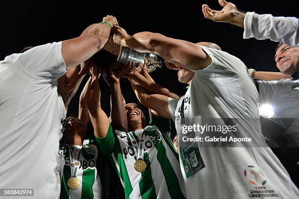 Players of Atletico Nacional celebrate with the trophy after a second leg final match between Atletico Nacional and Independiente del Valle as part...