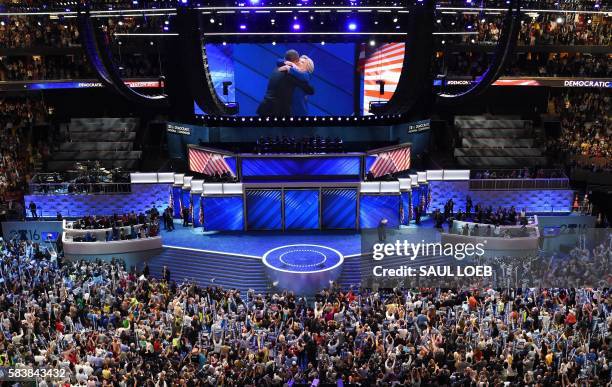 President Barack Obama and Democratic presidential nominee Hillary Clinton embrace on stage during Day 3 of the Democratic National Convention at the...