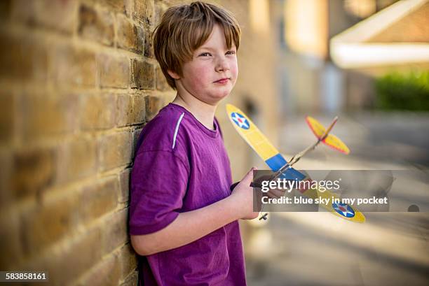 a young boy playing with a model airplane - preteen model stock pictures, royalty-free photos & images