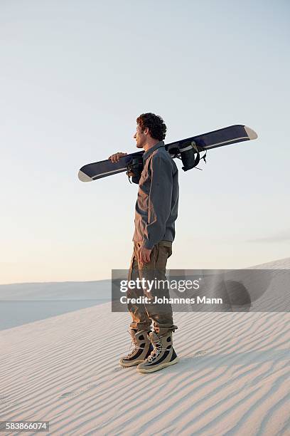 sandboarder standing in desert - sand boarding stock pictures, royalty-free photos & images