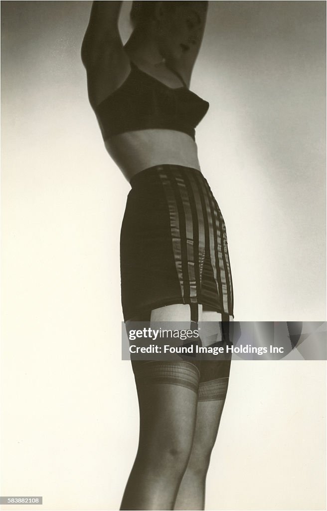 Woman in Black Garter Belt, Stockings, and Pointy Bra