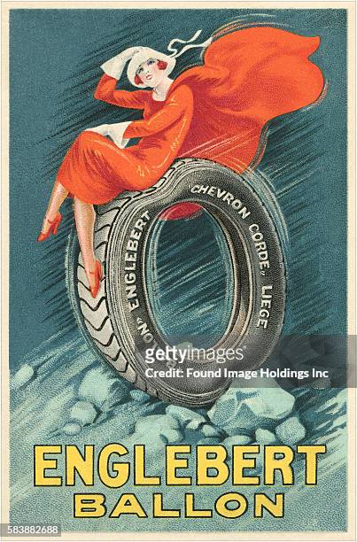 Vintage illustration of an tire advertisement featuring a flapper girl in red dress and blowing cape, holding her hat on, as she rides on a tire over...