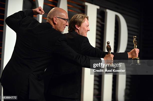 Roy Conli, left, and Don Hall hold their Oscars for best animated film for Big Hero 6 as they attend the 2015 Vanity Fair Oscar Party hosted by...