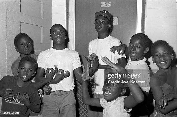 Young boys and members of the Grape Street Crip "throwing" their signature 'G' and 'W' hand signs. The Grape Street Watts Crips are a mostly African...