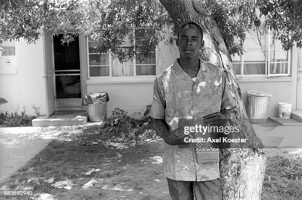 Members of the Grape Street Crips pose "throwing" their signature 'G' and 'W' hand signs. The Grape Street Watts Crips are a mostly African American...