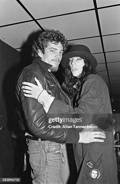 American couple, photographer and artist Robert Mapplethorpe and musician and poet Patti Smith, as they pose backstage at Max's Kansas City, New...