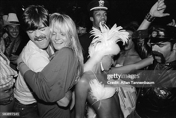 American model and actress Valerie Perrine dances with musicians David Hodo , Alex Briley and Glenn Hughes , all of the group the Village People,...